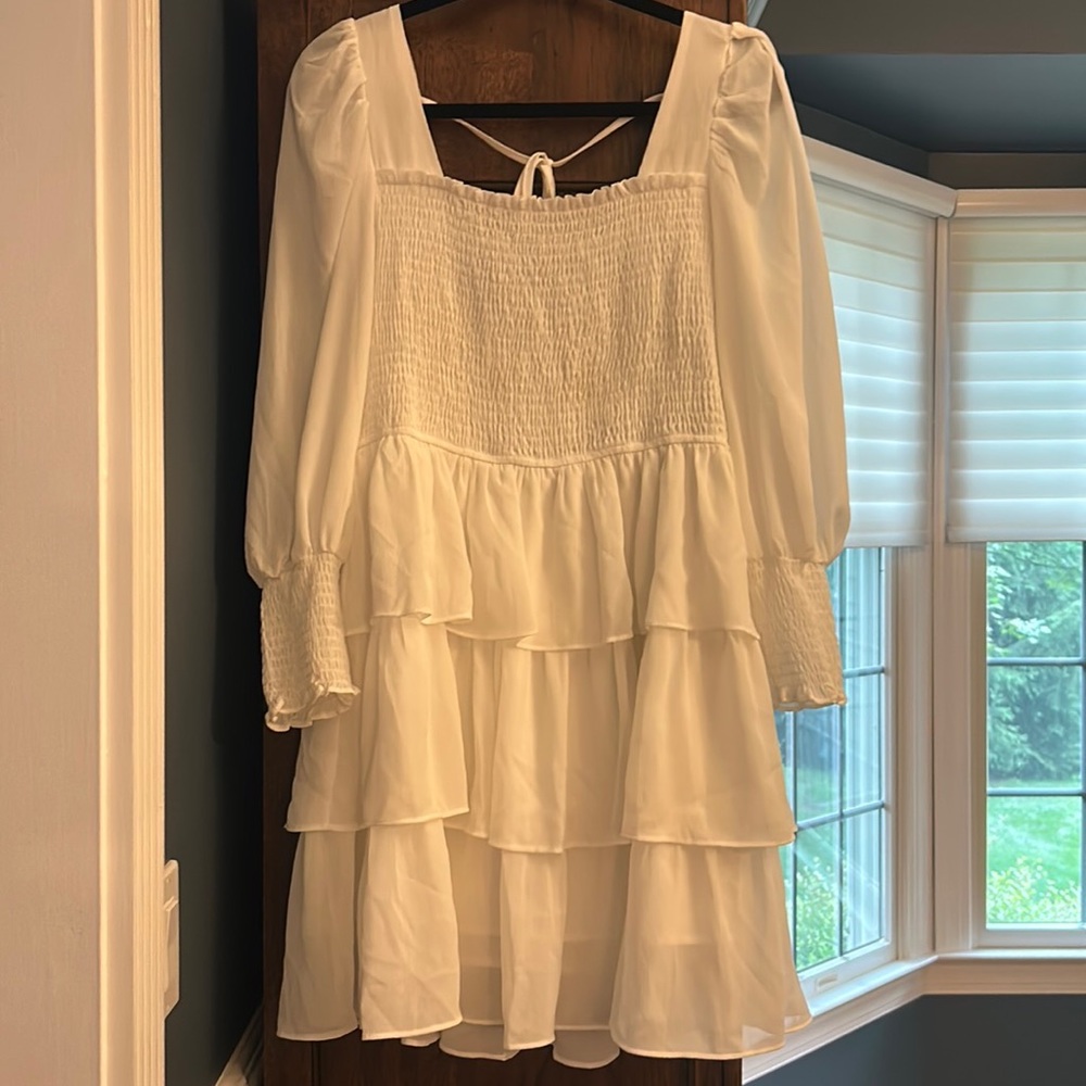 white ruffled dress lightly worn for sorority events